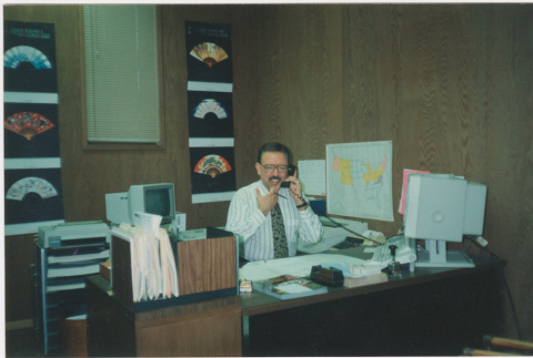 Man seated at desk in office (ddr-densho-426-1305)