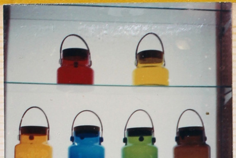 Display of colored glass bottles and jars (ddr-densho-426-1205)