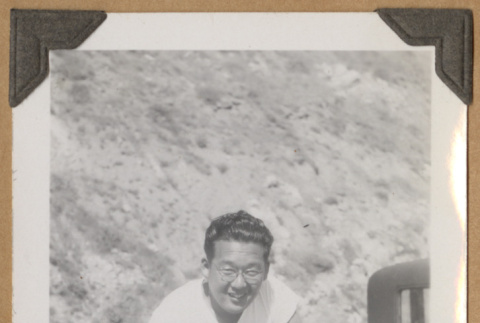 Man sitting on a car (ddr-densho-542-89)