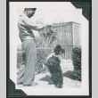 Man with dog doing standing trick (ddr-densho-475-568)