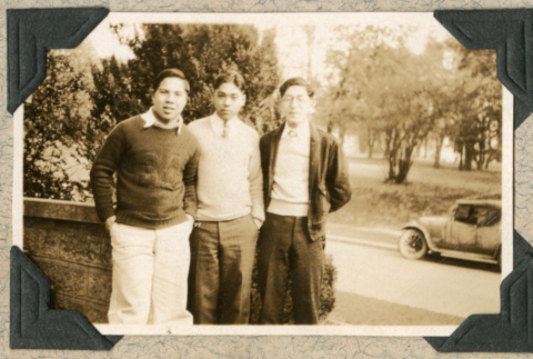 Three young men standing on porch (ddr-densho-383-33)