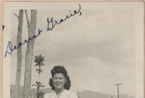 Signed photograph of a woman standing next to a tree (ddr-manz-10-21)