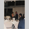 Couple at microphone in front of banquet tables (ddr-densho-466-545)