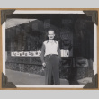 Man stands outside The Owl Drug Co. (ddr-densho-542-63)