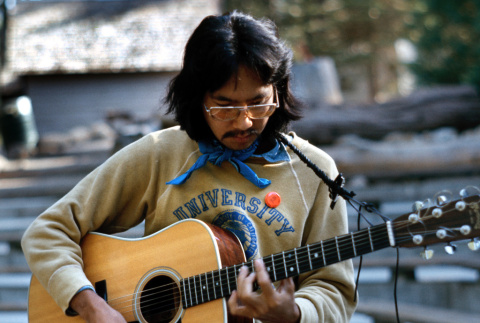 Peter Horikoshi playing guitar at morning watch (ddr-densho-336-360)