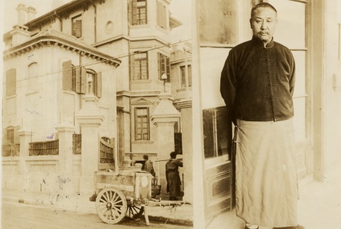 Yen Hsi-shan standing near a store front (ddr-njpa-1-289)