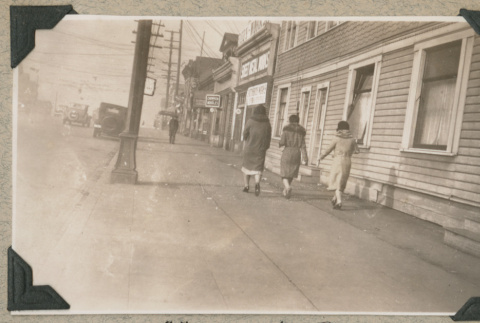 Three women walking down sidewalk (ddr-densho-383-40)