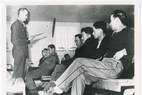 Seated figures addressed by military personnel (ddr-densho-1007-23)
