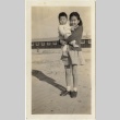Itoko Sano holding Lloyd Takasugi in Rohwer concentration camp (ddr-densho-331-9)