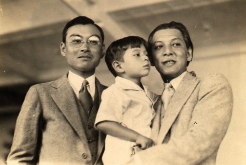Man holding son, posing with another man (ddr-njpa-4-136)