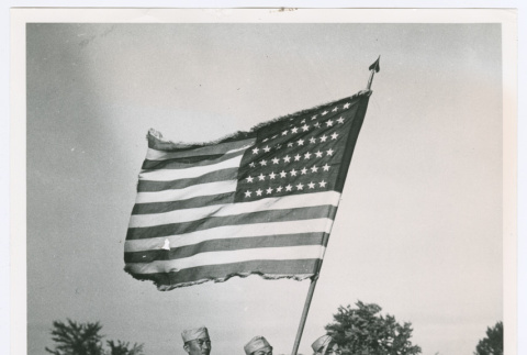 Three service people with American flag (ddr-densho-1007-42)