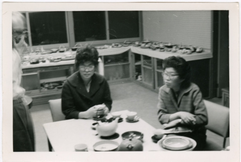 Tomoye Takahashi and woman (possibly Martha Suzuki) seated at table (ddr-densho-426-1110)