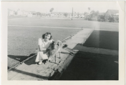 Woman sitting next to a dog (ddr-manz-7-38)