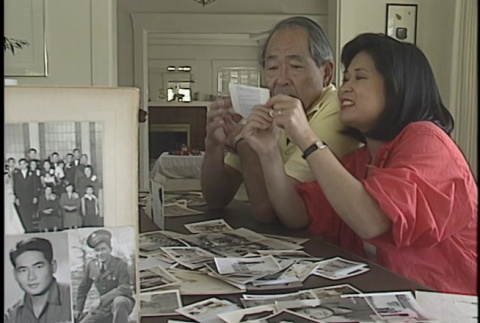 Haruo Howe Hanamura looking at photo albums (2 of 2) (ddr-ajah-6-306)