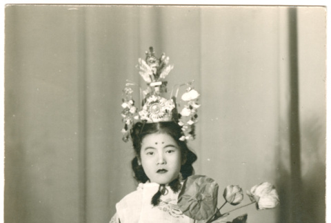Girl in costume holding flower (ddr-densho-430-221)