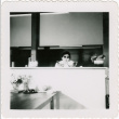 Woman behind counter at restaurant (ddr-densho-426-823)