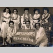 Japanese acting troupe posing with Nichibei Kinema banner (ddr-njpa-4-7)
