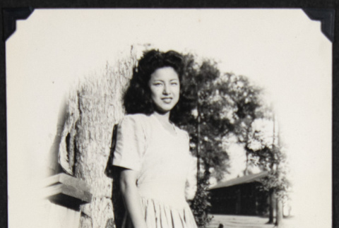 Doris Yuki leans against a tree (ddr-densho-542-617)