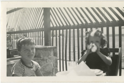 Two kids eating a meal (ddr-manz-7-60)