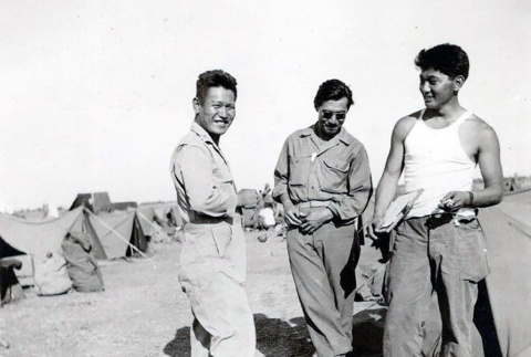 Three men in fatigues standing by tents (ddr-densho-474-239)