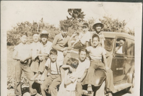 A group of teenagers and children sitting on a truck (ddr-densho-316-60)