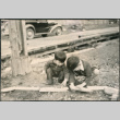 Two boys playing with a toy car (ddr-densho-523-111)