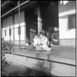 Two children seated outside house (ddr-densho-426-308)