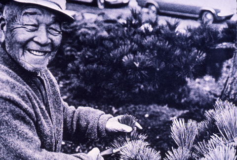 Fujitaro Kubota posing with plants, from Kraig Kemper's Thesis (ddr-densho-354-307)
