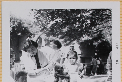 Yoshiko and Leslie Shiomi with other children with monkey in dress (ddr-densho-522-412)