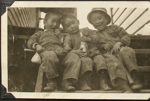 Three Nisei brothers on steps (ddr-densho-259-499)