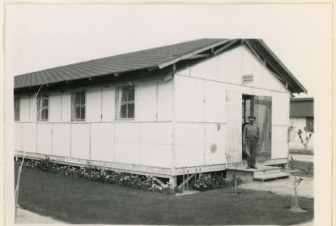 Man stands outside the grounds division (ddr-densho-37-1043)