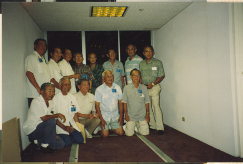 Group of 13 men in a hallway (ddr-densho-466-505)