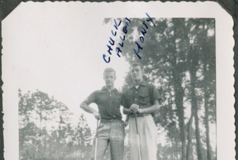 Two men stand with golf clubs (ddr-densho-321-387)