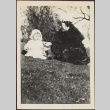 A woman and baby sitting outdoors (ddr-densho-278-202)