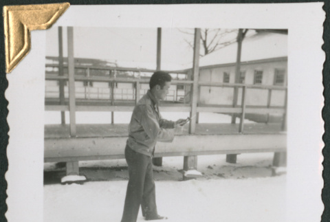 Man in snow holding something (ddr-densho-434-294)