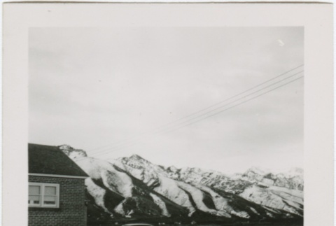 View of a house with mountains in the distance (ddr-densho-338-291)