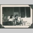 Two friends and a baby sitting on a front porch (ddr-densho-328-69)