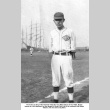 Man in baseball uniform with ships in background (ddr-ajah-5-57)