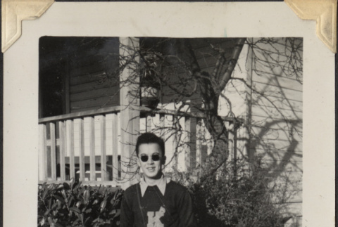 Man in sunglasses and letterman sweater (ddr-densho-466-911)
