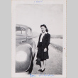 Woman standing next to car, Heart Mountain in background (ddr-densho-464-39)