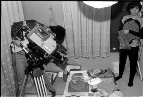 Taking photo of mask making station (ddr-densho-1007-1314)