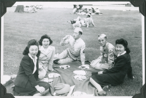 Three women and two men in uniform having a picnic (ddr-ajah-2-523)