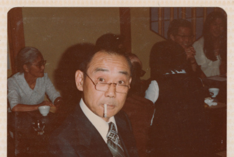 Man Smoking as He Unwraps Gift (ddr-ohs-1-265)