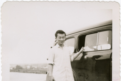 Men standing next to a car (ddr-densho-430-274)
