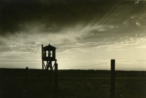 Guard tower and barbed wire (ddr-densho-159-13)