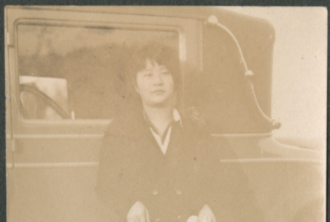 Woman leaning on car (ddr-densho-523-17)