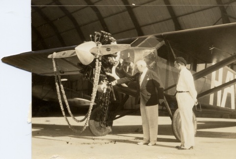 Two men looking at an airplane (ddr-njpa-1-2337)
