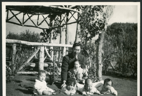Photograph of Henry Matsumoto with orphan incarcerees at Children's Village (ddr-csujad-47-162)