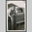 Man leaning on car with someone inside (ddr-densho-550-143)