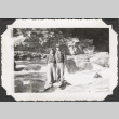 Couple standing by river rapids (ddr-densho-466-200)